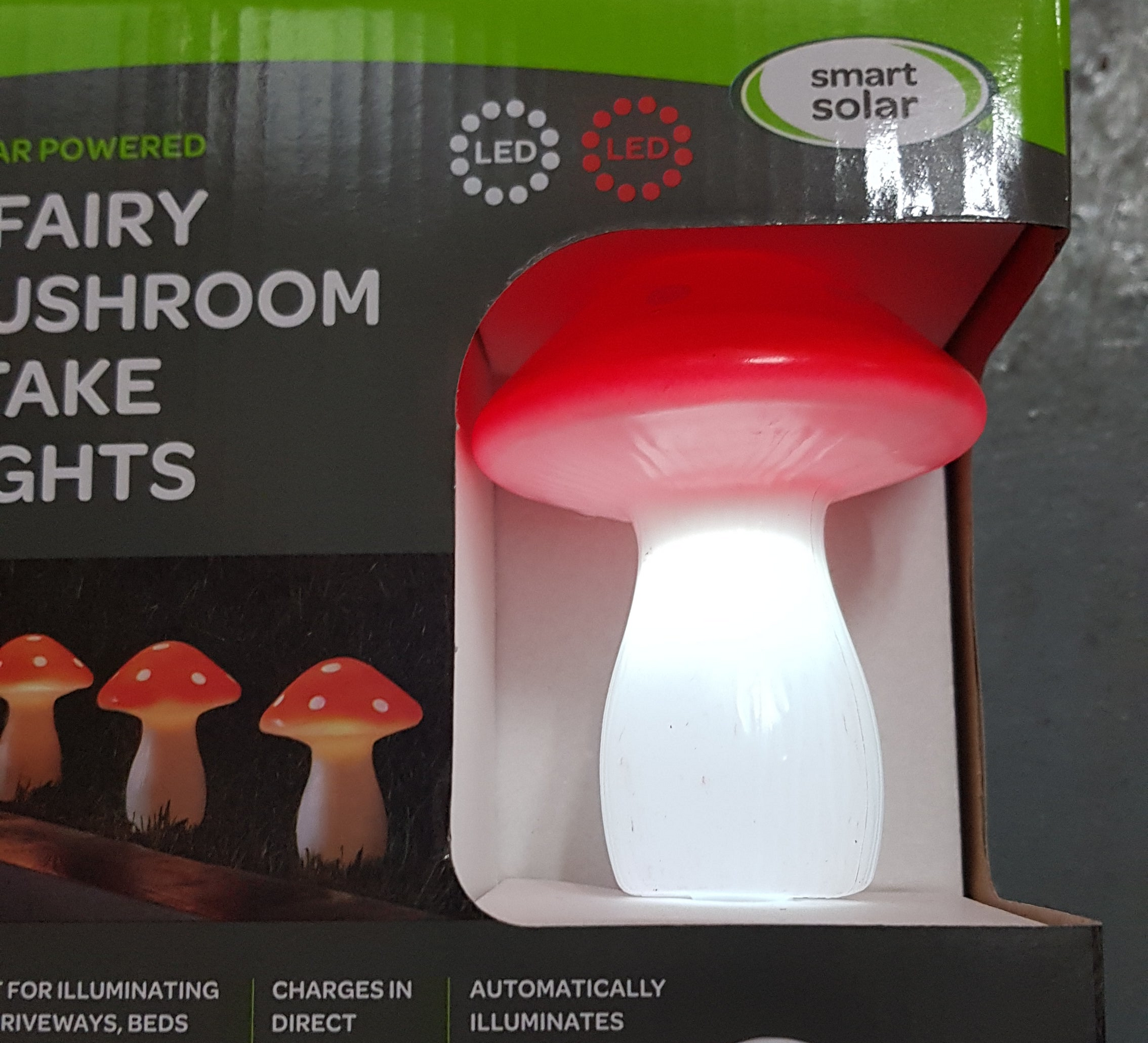 Fairy mushroom stake lights with red cap and white body, displayed in packaging